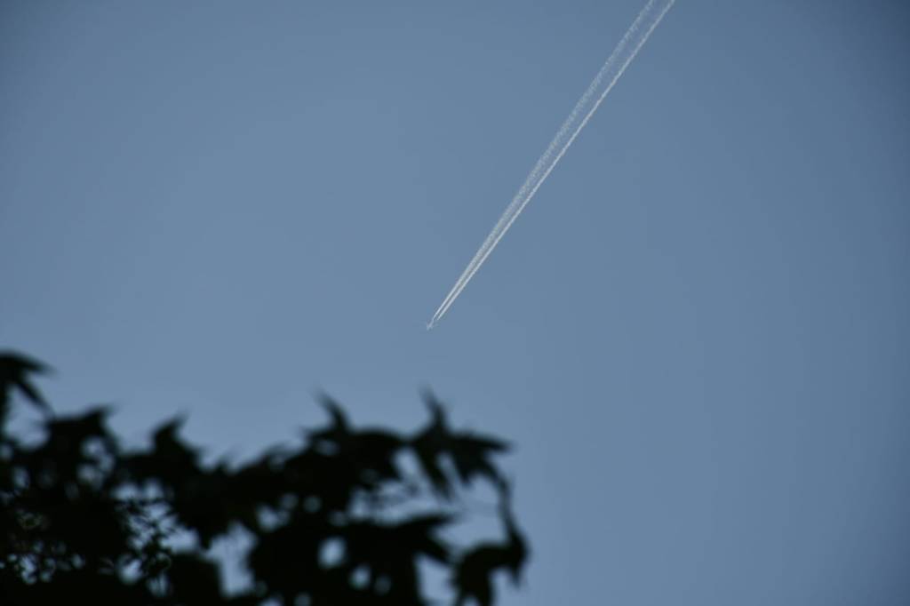 A picture of the sky with a plane casting a trail through it.