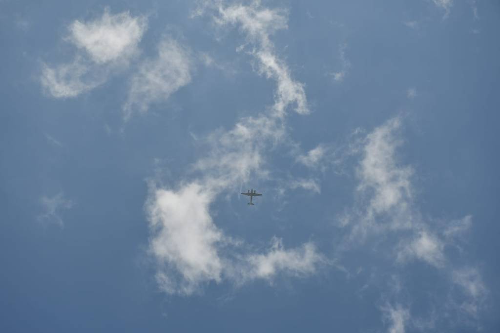 A picture of the sky and clouds with a plane in the middle of the clouds.